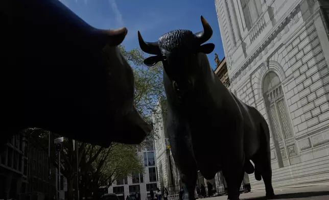 The bull and bear sculptures outside the stock market in Frankfurt, Germany, Wednesday, April 16, 2025. (AP Photo/Matthias Schrader)