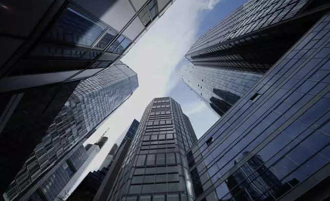 Clouds hang over buildings at the financial district in Frankfurt, Germany, Wednesday, April 16, 2025. (AP Photo/Matthias Schrader)