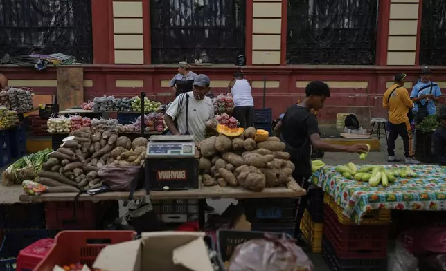 Vegetables sit for sale at a street market in Caracas, Venezuela, Friday, April 11, 2025. (AP Photo/Ariana Cubillos)