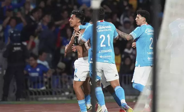 Angel Sepulveda of Mexico's Cruz Azul, left, celebrates scoring his side's 2nd goal against Mexico's America during a CONCACAF Champions Cup second leg quarterfinal soccer match in Mexico City, Tuesday, April 8, 2025. (AP Photo/Eduardo Verdugo)