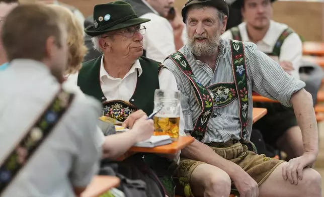 Men dressed in traditional clothes attend the German Championships in Fingerhakeln or finger wrestling, in Pang, near Rosenheim, Germany, Sunday, April 27, 2025. (AP Photo/Matthias Schrader)