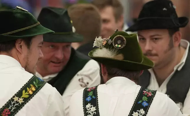 Men dressed in traditional clothes attend the German Championships in Fingerhakeln or finger wrestling, in Pang, near Rosenheim, Germany, Sunday, April 27, 2025. (AP Photo/Matthias Schrader)