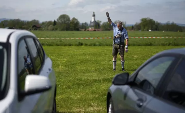 A competitor warms up for his bout while he try to pull the opponent over the table at the German Championships in Fingerhakeln or finger wrestling, in Pang, near Rosenheim, Germany, Sunday, April 27, 2025. (AP Photo/Matthias Schrader)
