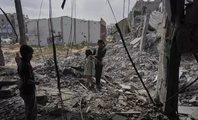 Palestinians look at the damage after an Israeli army airstrike in Beit Lahia, northern Gaza Strip, Monday, April 28, 2025. (AP Photo/Jehad Alshrafi)