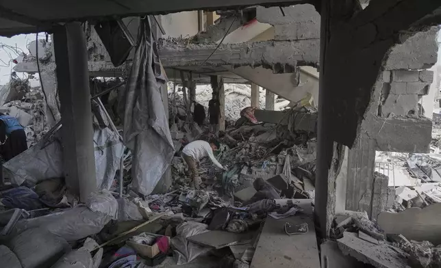 Palestinians look at the damage after an Israeli army airstrike in Beit Lahia, northern Gaza Strip, Monday, April 28, 2025. (AP Photo/Jehad Alshrafi)
