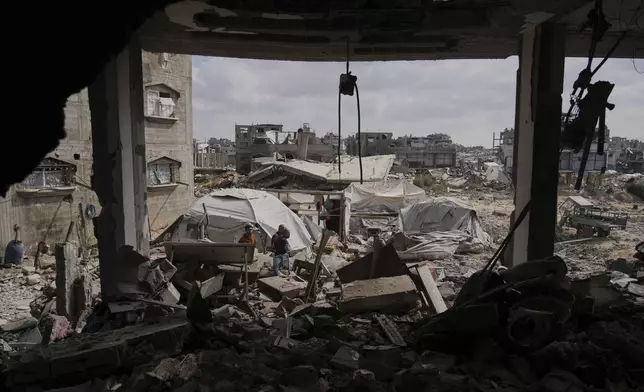 Palestinians look at the damage after an Israeli army airstrike in Beit Lahia, northern Gaza Strip, Monday, April 28, 2025. (AP Photo/Jehad Alshrafi)