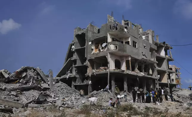 Palestinians look at the damage after an Israeli army airstrike in Beit Lahia, northern Gaza Strip, Monday, April 28, 2025. (AP Photo/Jehad Alshrafi)