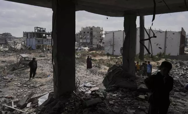 Palestinians look at the damage after an Israeli army airstrike in Beit Lahia, northern Gaza Strip, Monday, April 28, 2025. (AP Photo/Jehad Alshrafi)