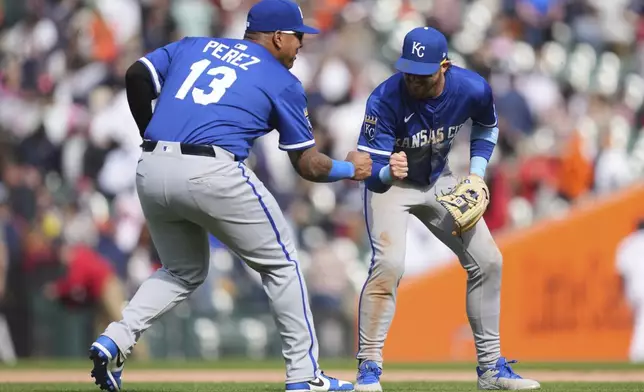 Kansas City Royals' Salvador Perez (13) and Bobby Witt Jr. celebrate after the final out against the Detroit Tigers in the tenth inning during a baseball game, Sunday, April 20, 2025, in Detroit. (AP Photo/Paul Sancya)