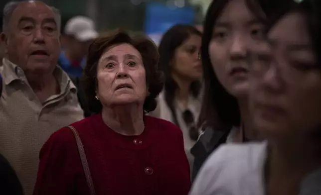 Passengers react as they wait for news of train departures, at Sants train station in Barcelona, Spain, Tuesday, April 29, 2025. (AP Photo/Emilio Morenatti)