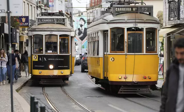 Electric trams drive through Lisbon, Tuesday, April 29, 2025, the day after a nationwide power outage that stopped trams, trains and subways. (AP Photo/Armando Franca)
