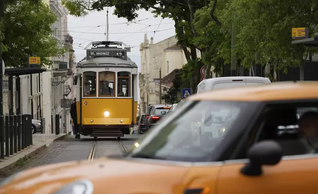 An electric tram drives uphill in Lisbon, Tuesday, April 29, 2025, the day after a nationwide power outage that stopped trams, trains and subways. (AP Photo/Armando Franca)