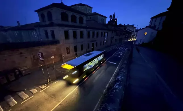 A city bus goes by the historic city of Santiago, Spain during a major power outage across Spain and Portugal Monday, April, 28, 2025. (AP Photo/Mic Smith)