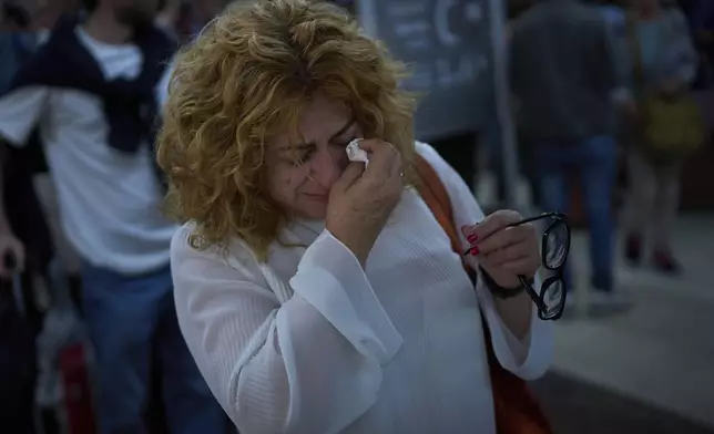 Paquita Gonzalez cries as she waits for news of train departures, after spending the whole night at the station Sants station in Barcelona, Spain, Tuesday, April 29, 2025. (AP Photo/Emilio Morenatti)