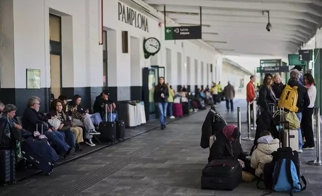 Passengers wait at a train station during a nationwide power outage in Pamplona, northern Spain, on Monday, April 28, 2025. (AP Photo/Miguel Oses)