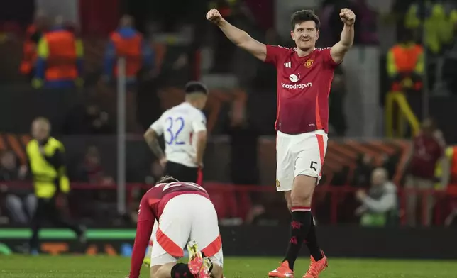 Manchester United's Harry Maguire celebrates besides Luke Shaw after the Europa League quarter final second leg soccer match between Manchester United and Olympique Lyon in Manchester, Britain, Thursday, April 17, 2025. (AP Photo/Jon Super)