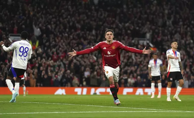 Manchester United's Manuel Ugarte celebrates after scoring his side's opening goal during the Europa League quarter final second leg soccer match between Manchester United and Olympique Lyon in Manchester, England, Thursday, April 17, 2025. (Martin Rickett/PA via AP)