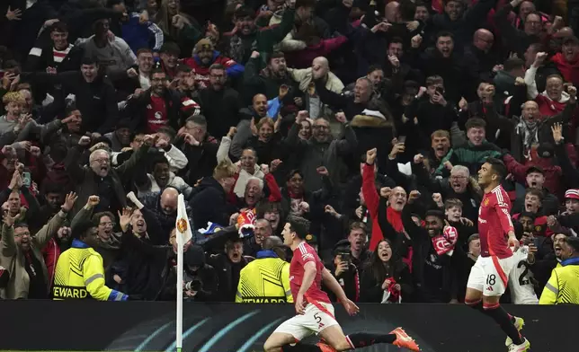 Manchester United's Harry Maguire, left, celebrates with team mates after his side's fifth goal during the Europa League quarter final second leg soccer match between Manchester United and Olympique Lyon in Manchester, Britain, Thursday, April 17, 2025. (AP Photo/Jon Super)
