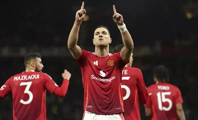 Manchester United's Diogo Dalot celebrates scoring during the Europa League quarterfinal second leg soccer match between Manchester United and Olympique Lyon in Manchester, England, Thursday, April 17, 2025. (Martin Rickett/PA via AP)