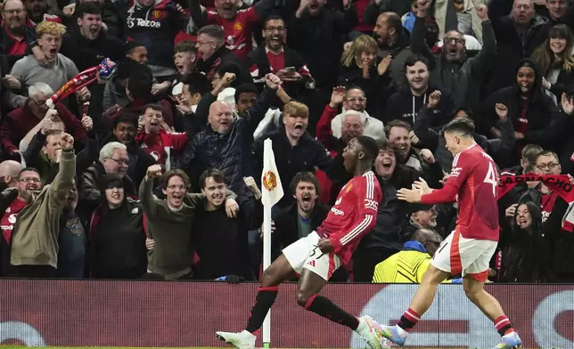 Manchester United's Kobbie Mainoo celebrates after scoring his side's fourth goal during the Europa League quarter final second leg soccer match between Manchester United and Olympique Lyon in Manchester, Britain, Thursday, April 17, 2025. (AP Photo/Jon Super)