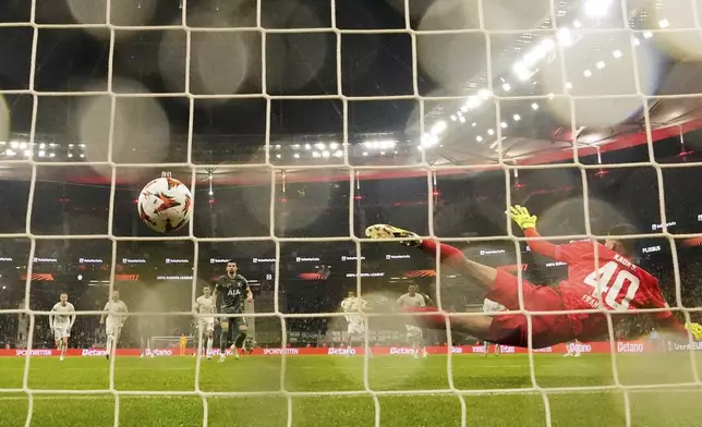 Tottenham's Dominic Solanke scores the opening goal from the penalty spot against Frankfurt's goalkeeper Kaua Santos during the Europa League quarterfinal second leg soccer match between Eintracht Frankfurt and Tottenham Hotspur, in Frankfurt, Germany, Thursday, April 17, 2025. (AP Photo/Martin Meissner)