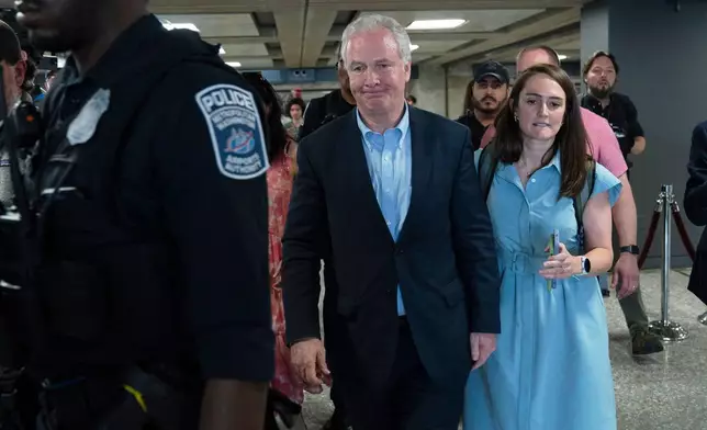 Sen. Chris Van Hollen, D-Md., left, walks in the terminal after speaking during a news conference upon his arrival from meeting with Kilmar Abrego Garcia in El Salvador, at Washington Dulles International Airport, in Chantilly, Va., Friday, April 18, 2025. (AP Photo/Jose Luis Magana)