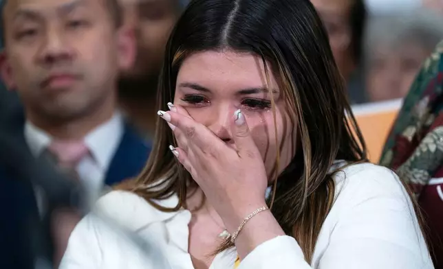 Jennifer Vasquez Sura wipes a tear from her face as Sen. Chris Van Hollen, D-Md., speaks during a news conference upon his arrival from meeting with her husband, Kilmar Abrego Garcia, in El Salvador, at Washington Dulles International Airport, in Chantilly, Va., Friday, April 18, 2025. (AP Photo/Jose Luis Magana)