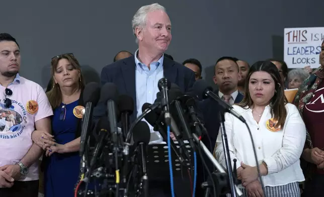 Sen. Chris Van Hollen, D-Md., center, accompanied by Cesar Abrego Garcia, from left, Cecilia Garcia and Jennifer Vasquez Sura, speaks during a news conference upon his arrival from meeting with Kilmar Abrego Garcia in El Salvador, at Washington Dulles International Airport, in Chantilly, Va., Friday, April 18, 2025. (AP Photo/Jose Luis Magana)