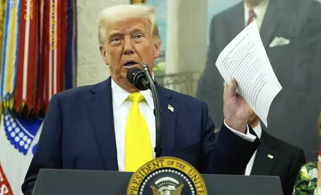 President Donald Trump holds a document with notes about Kilmar Abrego Garcia as he speaks with reporters during a swearing in ceremony for Dr. Mehmet Oz to be Administrator of the Centers for Medicare and Medicaid Services, in the Oval Office of the White House, Friday, April 18, 2025, in Washington. (AP Photo/Alex Brandon)