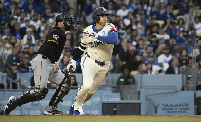 Los Angeles Dodgers' Shohei Ohtani tracks his triple during the fifth inning of a baseball game against the Pittsburgh Pirates in Los Angeles, Saturday, April 26, 2025. (AP Photo/Kyusung Gong)