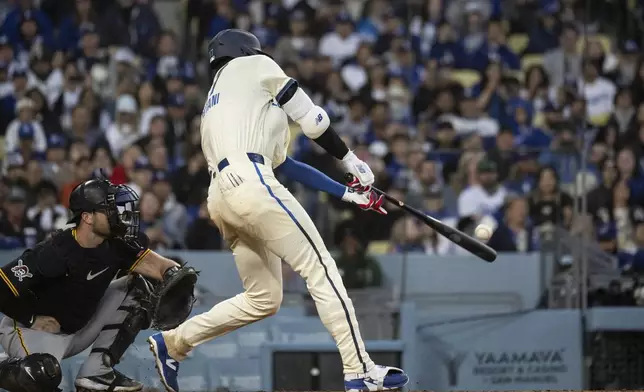 Los Angeles Dodgers' Shohei Ohtani hits a triple during the fifth inning of a baseball game against the Pittsburgh Pirates in Los Angeles, Saturday, April 26, 2025. (AP Photo/Kyusung Gong)