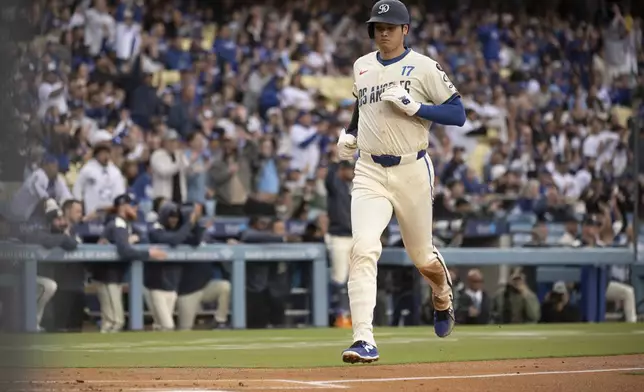 Los Angeles Dodgers' Shohei Ohtani scores on a double by Teoscar Hernández during the first inning of a baseball game against the Pittsburgh Pirates in Los Angeles, Saturday, April 26, 2025. (AP Photo/Kyusung Gong)