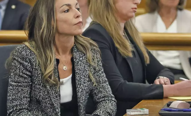 Karen Read sits with attorney Victoria George, who was a juror on her first trial and now part of her defense team, during Read's second trial for the 2022 death of her boyfriend John O'Keefe on Wednesday, April 16, 2025 in Dedham, Mass. (Greg Derr/The Patriot Ledger via AP, Pool)