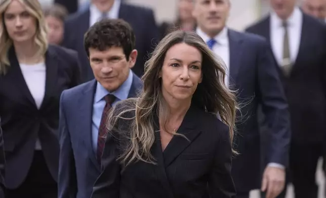 Karen Read arrives with her defense team for her trial at Norfolk Superior Court, Tuesday, April 22, 2025, in Dedham, Mass. (AP Photo/Charles Krupa)