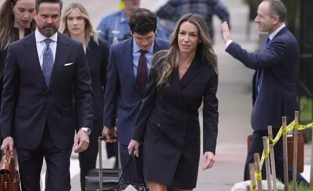 Karen Read arrives with her defense team for her trial at Norfolk Superior Court, Tuesday, April 22, 2025, in Dedham, Mass. (AP Photo/Charles Krupa)