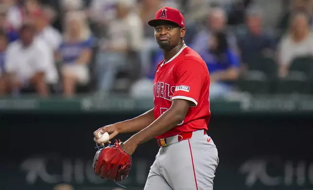 Los Angeles Angels starting pitcher José Soriano reacts after giving up an infield hit to Texas Rangers' Marcus Semien during the sixth inning of a baseball game Wednesday, April 16, 2025, in Arlington, Texas. (AP Photo/Julio Cortez)