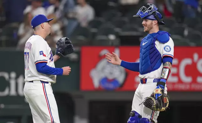 Texas Rangers pitcher Luke Jackson, left, and catcher Jonah Heim react after a baseball game against the Los Angeles Angels Wednesday, April 16, 2025, in Arlington, Texas. (AP Photo/Julio Cortez)