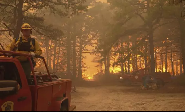 Smoke fills the sky as firefighters battle a wildfire in Lacey Townships, N.J. on Tuesday, April 22, 2025. (New Jersey Department of Environmental Protection via AP)