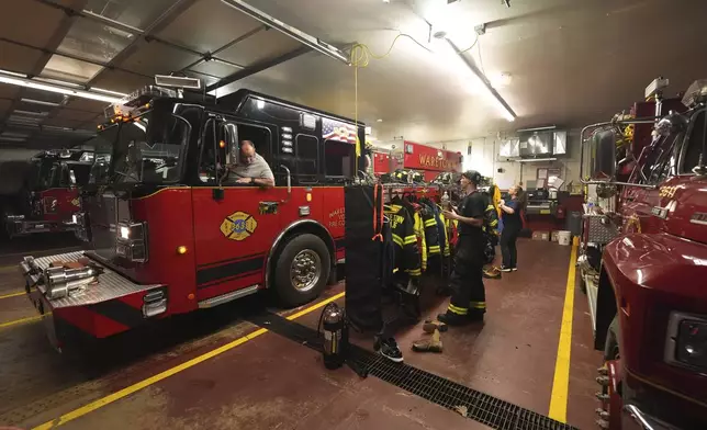 Waretown Volunteer Fire Company firefighters prepare to respond to a wildfire on Tuesday, April 22, 2025, in Waretown, N.J. (AP Photo/Chris Szagola)