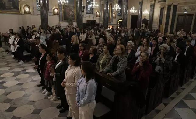 Greek Catholic believers and foreigners who live in Greece attend the mass of last supper at the Catholic Cathedral Basilica of St Dionysius the Areopagite in Athens, Greece, Holy Thursday, April 17, 2025. (AP Photo/Thanassis Stavrakis)