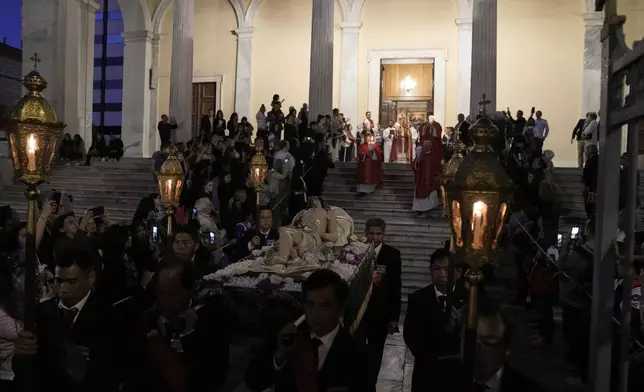 Greek Catholic believers and foreigners who live in Greece attend the Epitaph Procession at the Catholic Cathedral Basilica of St Dionysius the Areopagite in Athens, Greece, Good Friday, April 18, 2025. (AP Photo/Thanassis Stavrakis)