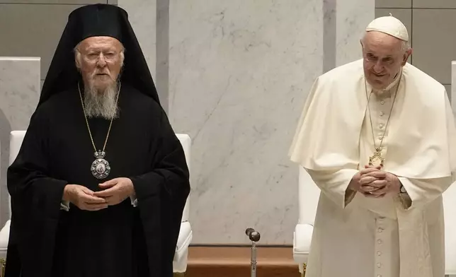 FILE - Pope Francis and Ecumenical Patriarch Bartholomew attend an ecumenical meeting and prayer for peace in Our Lady of Arabia Cathedral, Sakhir, Bahrain, Friday, Nov. 4, 2022. (AP Photo/Alessandra Tarantino, File)