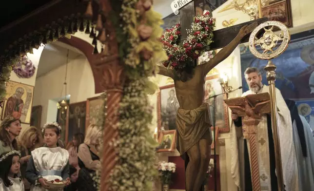 Believers attend the Good Friday reenactment of Deposition of Jesus Christ, at Agios Antonios church in the northern suburb of Chalandri, in Athens, Greece, Friday, April 18, 2025. (AP Photo/Thanassis Stavrakis)