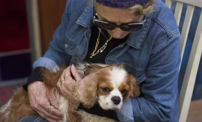 Rachel Dancyg holds her dog, Billie, on Wednesday, April 16, 2025. Israeli soldiers found Billie in the Gaza Strip, 18 months after she disappeared during Hamas' attack on Dancyg's Kibbutz of Nir Oz, in Binyamina, Israel. (AP Photo/Ariel Schalit)