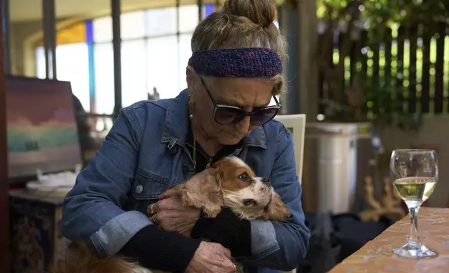 Rachel Dancyg holds her dog, Billie, on Wednesday, April 16, 2025. Israeli soldiers found Billie in the Gaza Strip, 18 months after she disappeared during Hamas' attack on Dancyg's Kibbutz of Nir Oz, in Binyamina, Israel. (AP Photo/Ariel Schalit)