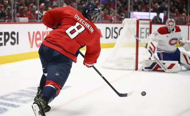 Washington Capitals left wing Alex Ovechkin (8) shoots against Montreal Canadiens goaltender Sam Montembeault (35) in the first period of Game 1 of a first-round NHL hockey playoff series Monday, April 21, 2025, in Washington. (AP Photo/Nick Wass)