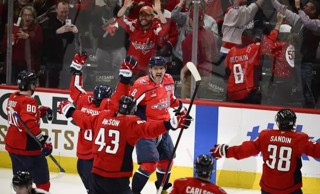 Washington Capitals left wing Alex Ovechkin (8) celebrates after his winning goal in overtime of Game 1 of a first-round NHL hockey playoff series past against the Montreal Canadiens, Monday, April 21, 2025, in Washington. (AP Photo/Nick Wass)