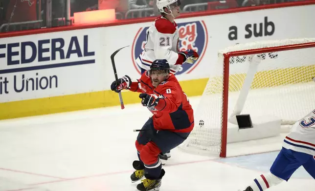 Washington Capitals left wing Alex Ovechkin (8) celebrates after his winning goal as Montreal Canadiens defenseman Kaiden Guhle (21) looks on in overtime of Game 1 of a first-round NHL hockey playoff series Monday, April 21, 2025, in Washington. (AP Photo/Nick Wass)
