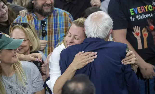 An attendee hugs Sen. Bernie Sanders, I-Vt., after his "Fighting Oligarchy" event at the Ford Idaho Center in Nampa, Idaho, Monday, April 14, 2025. (AP Photo/Kyle Green)