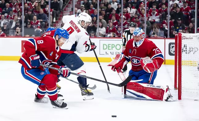 Washington Capitals' Alex Ovechkin, center, attempts to score against Montreal Canadiens goaltender Jakub Dobes (75) while defended by Canadiens' Mike Matheson, left, during the second period of Game 3 of a first-round NHL hockey playoff series in Montreal, Friday, April 25, 2025. (Christopher Katsarov/The Canadian Press via AP)